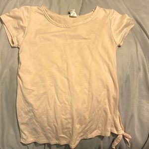 Peach colored shirt with tied side.